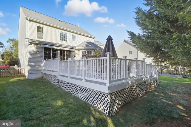 a view of a house with a yard and deck