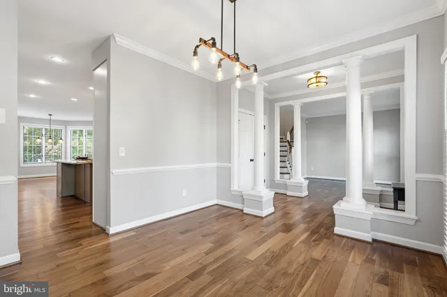 a view of a living room with hardwood floor and a ceiling fan