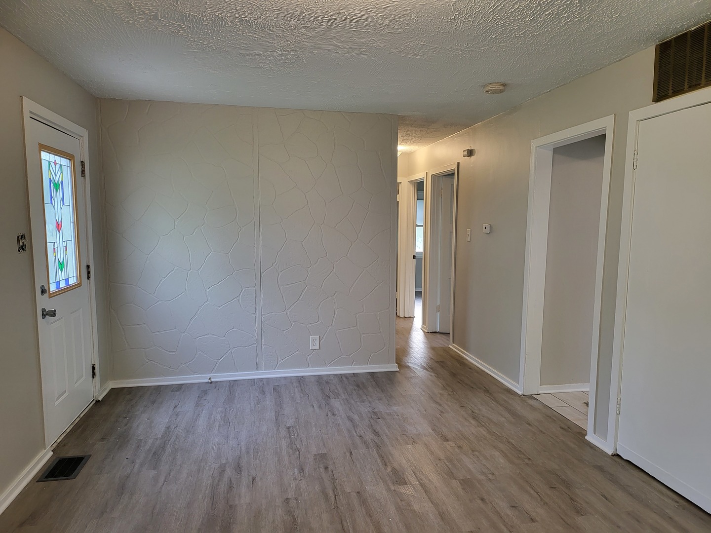 110 Walden Road Joliet, IL 60433 - Photo 5 of 20 an empty room with wooden floor and windows