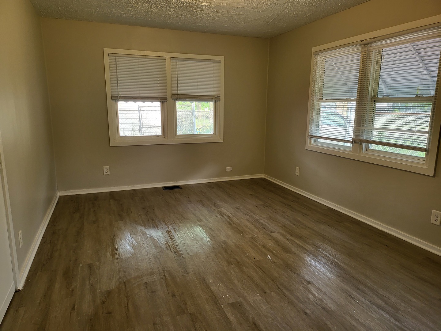 110 Walden Road Joliet, IL 60433 - Photo 8 of 20 a view of a room with wooden floor and windows