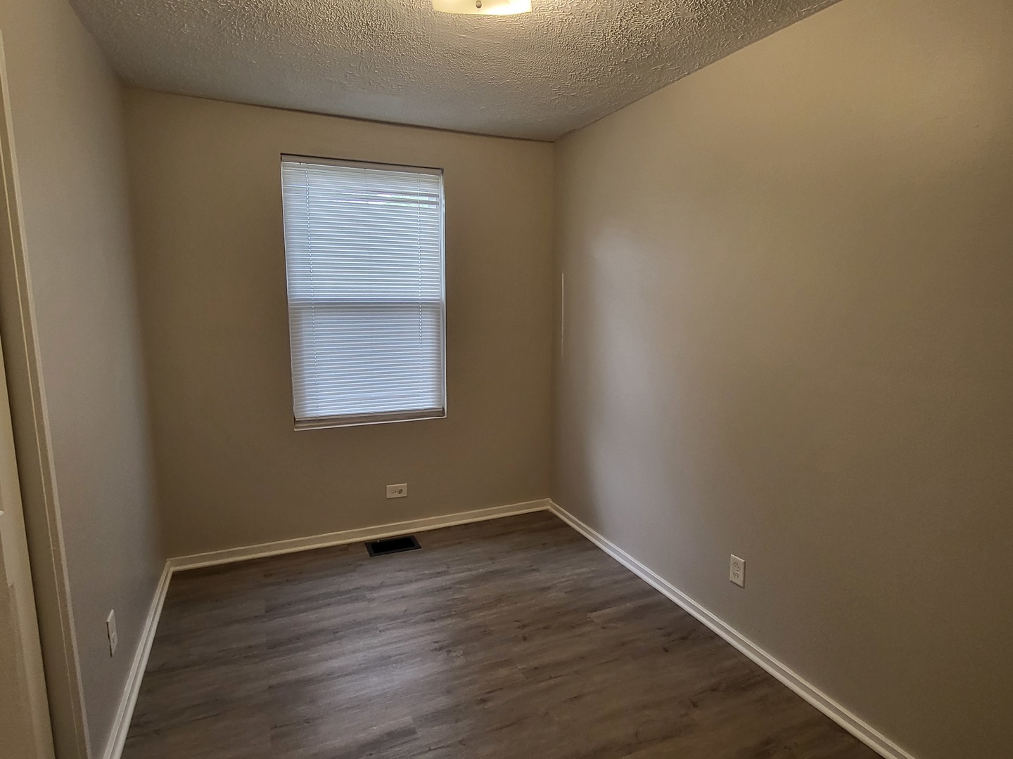 110 Walden Road Joliet, IL 60433 - Photo 9 of 20 an empty room with wooden floor and windows