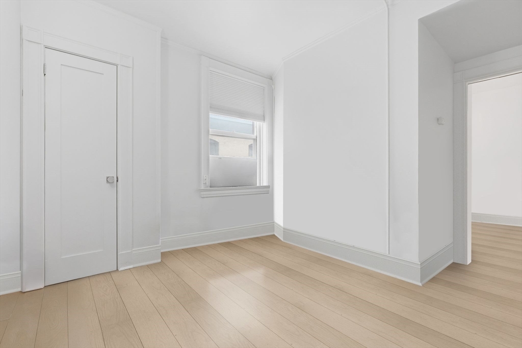 21 Beacon Street, Unit 11L Boston, MA 02108 - Photo 3 of 23 a view of an empty room and wooden floor