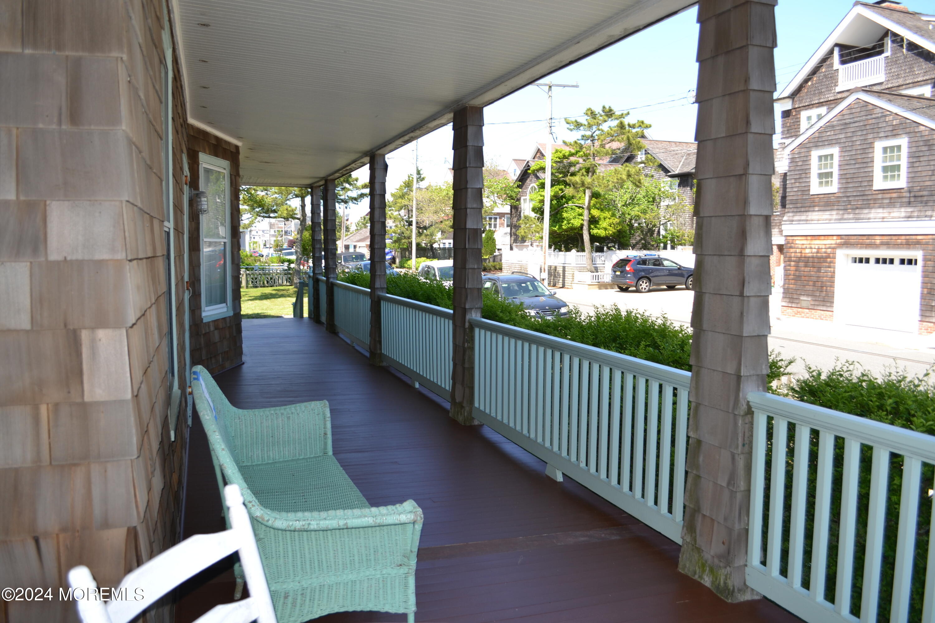 18 Bridge Avenue Bay Head, NJ 08742 - Photo 4 of 20 a view of a porch with wooden floor and outdoor seating