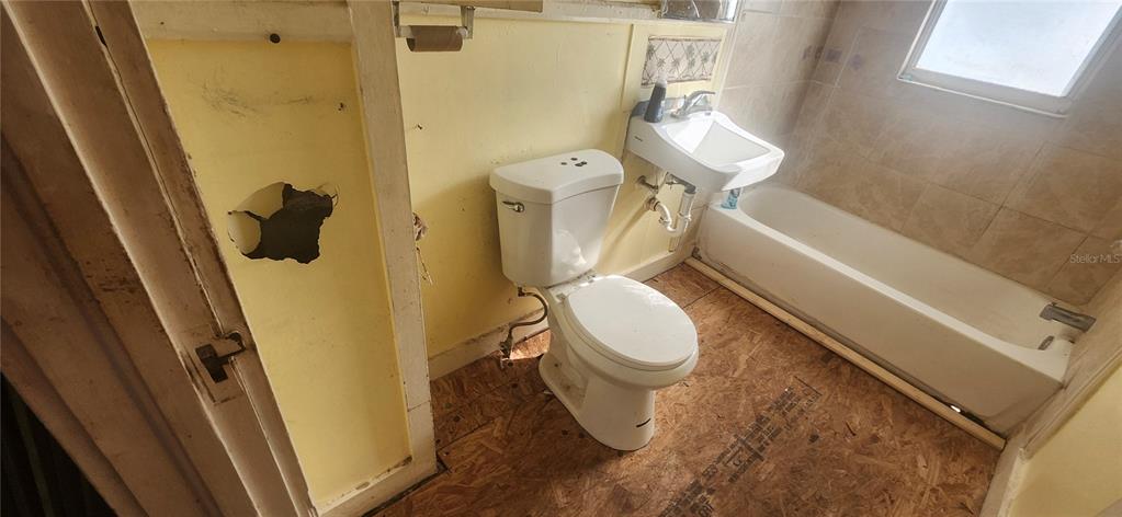 5212 Limestone Drive Port Richey, FL 34668 - Photo 5 of 17 a white toilet sitting next to a small sink