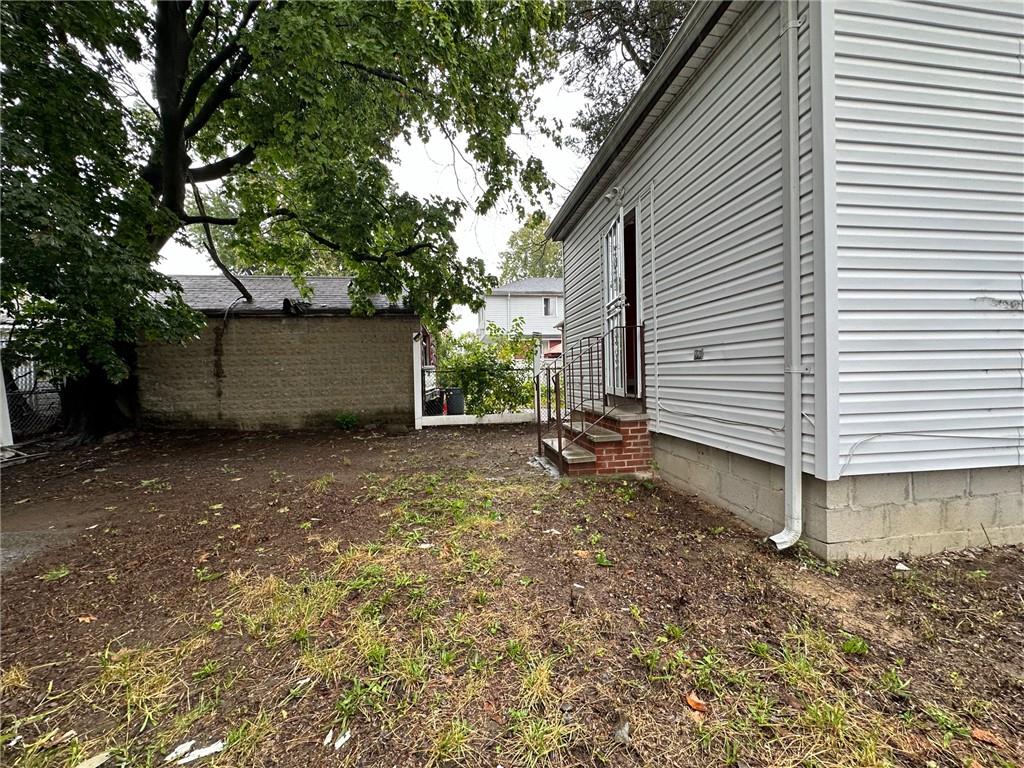 143-20 182nd Place Queens, NY 11413 - Photo 15 of 17 a view of a house with a yard and garage