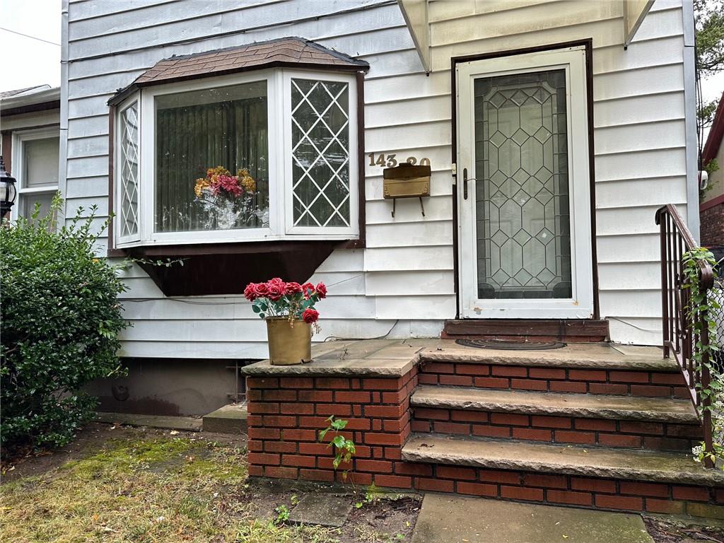 143-20 182nd Place Queens, NY 11413 - Photo 3 of 17 a front view of a house with a garden