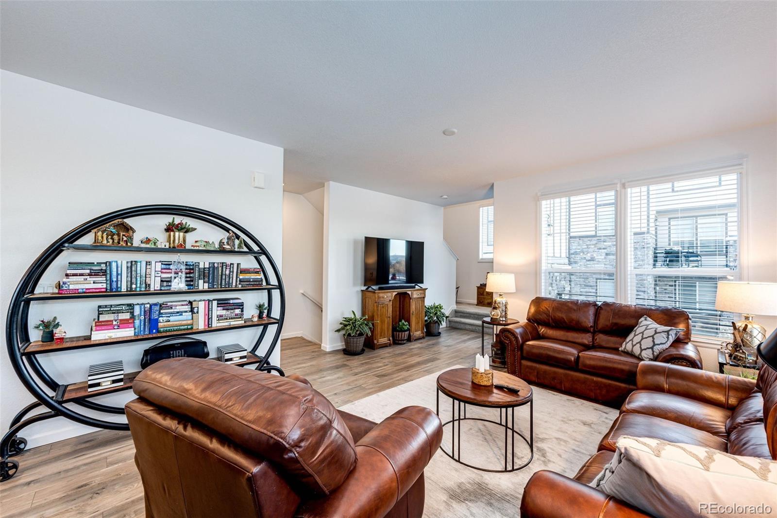 1532 Castle Creek Circle Castle Rock, CO 80104 - Photo 11 of 39 a living room with furniture a couch and a flat screen tv with wooden floor