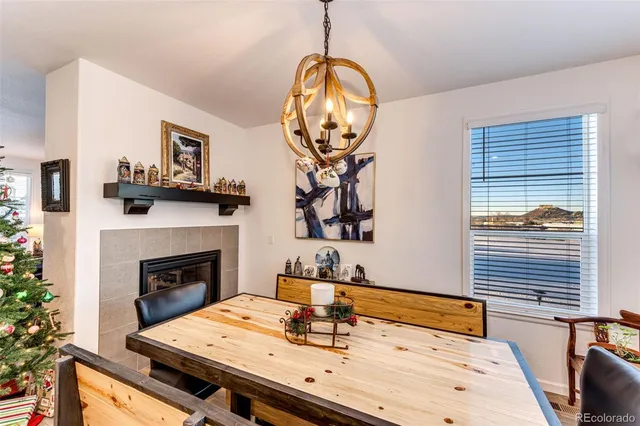 a dining room with fireplace furniture and a potted plant