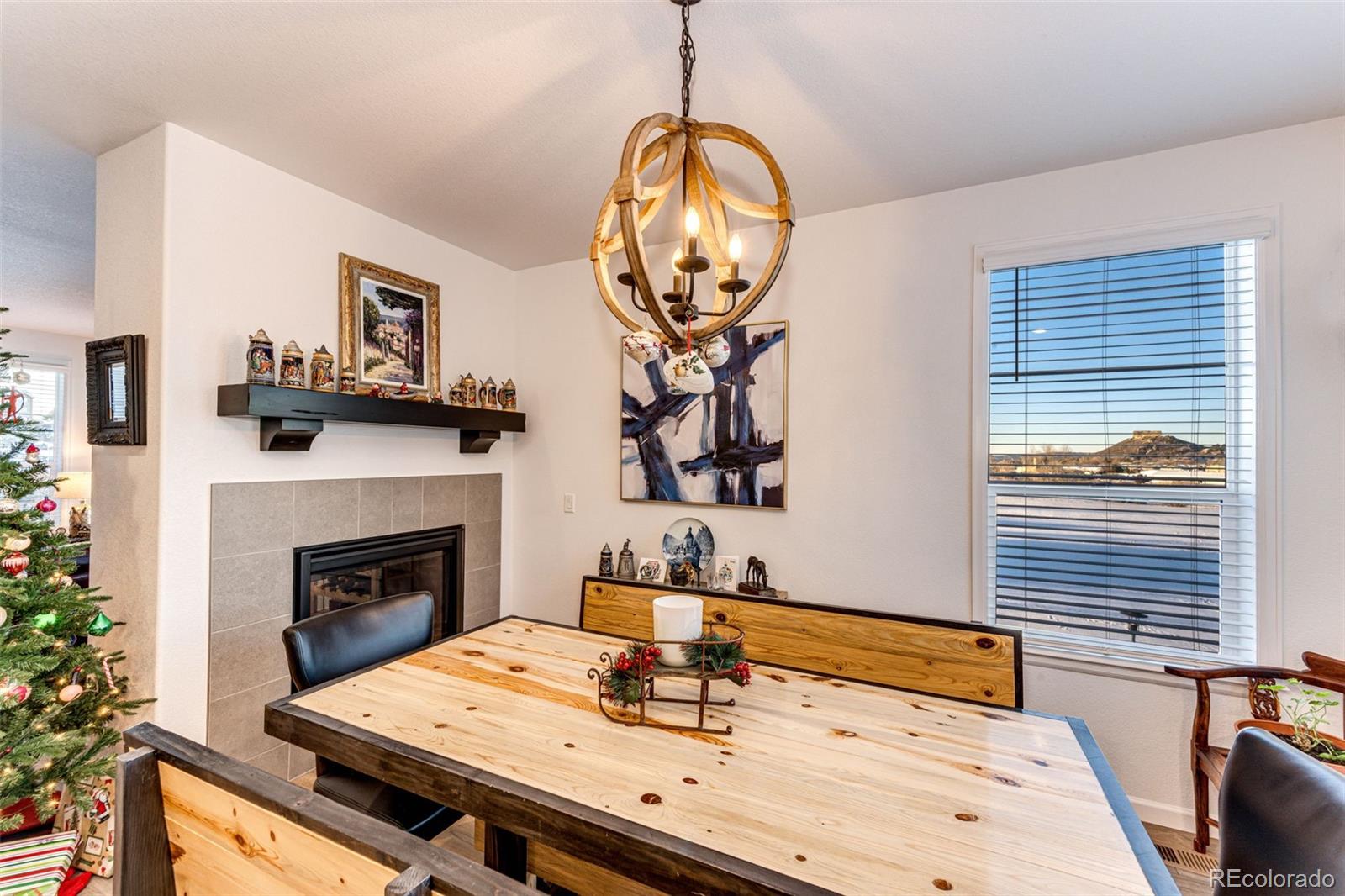1532 Castle Creek Circle Castle Rock, CO 80104 - Photo 14 of 39 a dining room with fireplace furniture and a potted plant