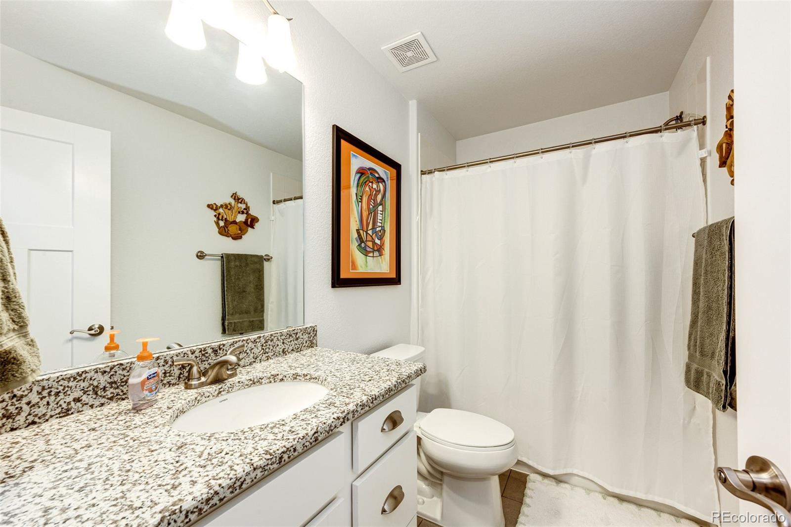 1532 Castle Creek Circle Castle Rock, CO 80104 - Photo 20 of 39 a bathroom with a granite countertop sink and a mirror