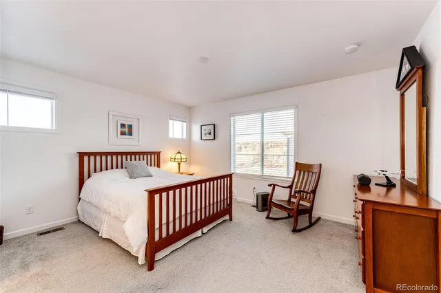 a bedroom with furniture and a window