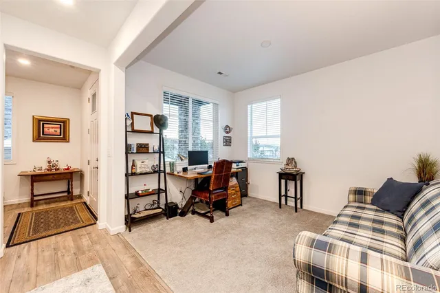 a bedroom with furniture and a book shelf