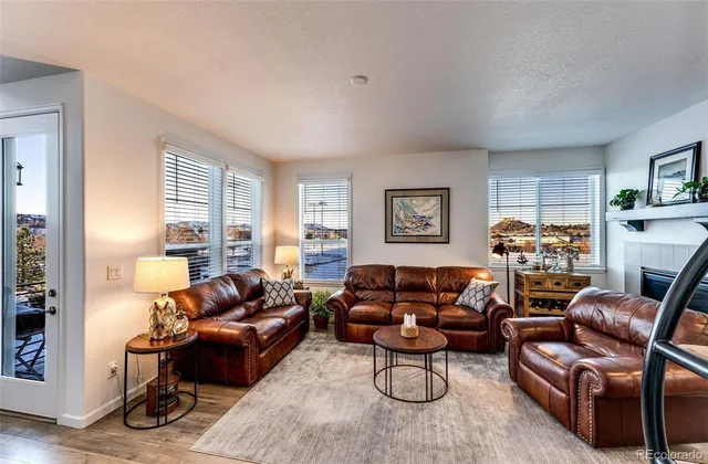 a living room with furniture a couch and a window