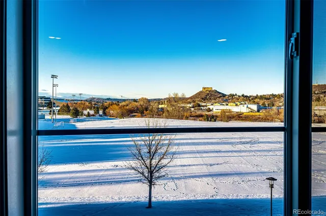 a view of a room with a large window and front door