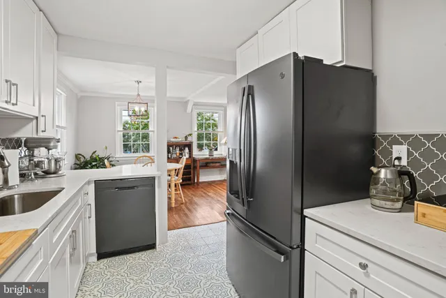 a kitchen with refrigerator and cabinets