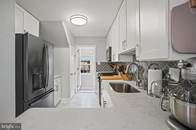a kitchen with stainless steel appliances granite countertop a refrigerator and a sink