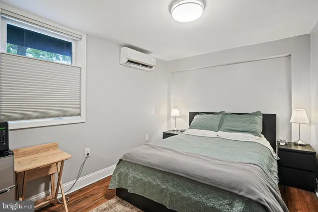 a bedroom with a bed and a window