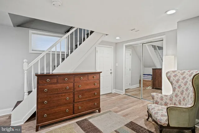 a view of entryway and hall with wooden floor