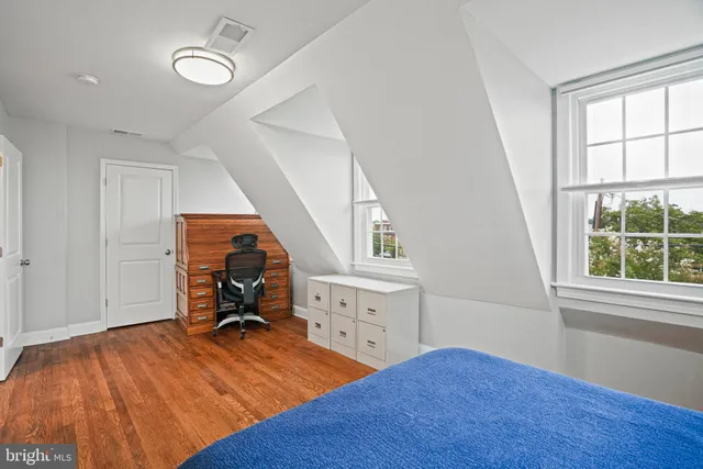 an empty room with a hardwood and a window