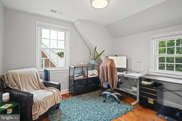 a bedroom with bed and windows