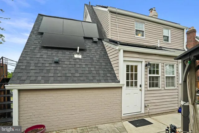 a view of a backyard with table and chairs potted plants and a palm tree