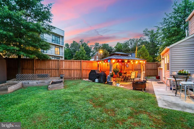 a view of a house with a backyard porch and sitting area