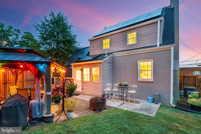an outdoor living space with patio furniture