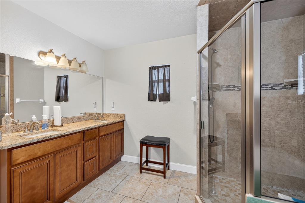 1922 Matthew Court Lakeland, FL 33813 - Photo 14 of 41 a spacious bathroom with a double vanity sink a mirror and a shower