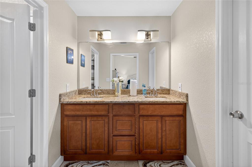 1922 Matthew Court Lakeland, FL 33813 - Photo 20 of 41 a bathroom with a granite countertop sink and a mirror