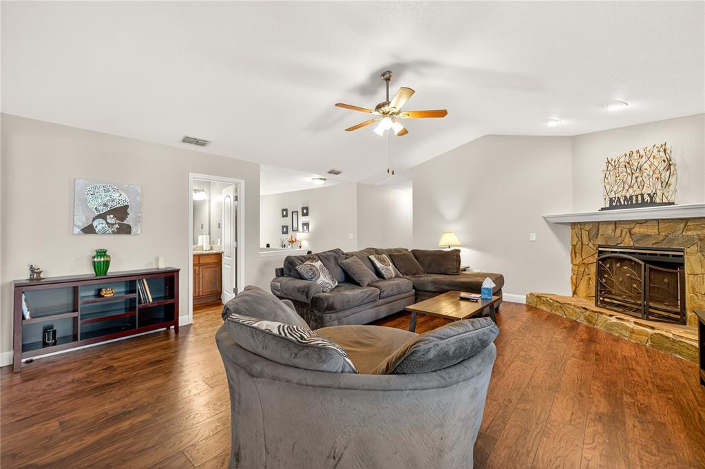1922 Matthew Court Lakeland, FL 33813 - Photo 6 of 41 a living room with furniture a fireplace and wooden floor