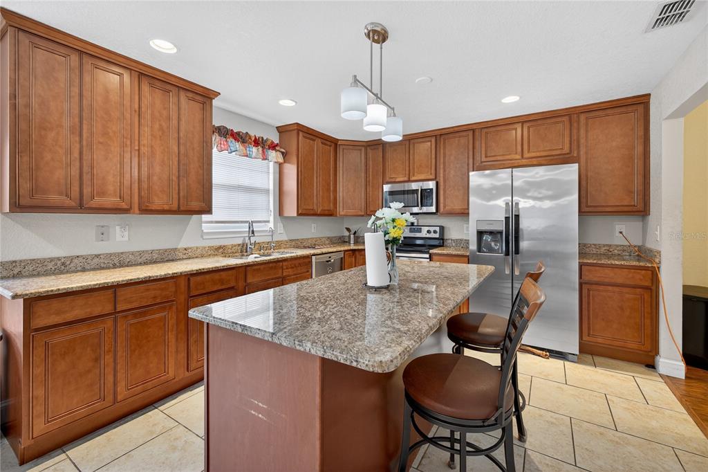 1922 Matthew Court Lakeland, FL 33813 - Photo 7 of 41 a kitchen with stainless steel appliances granite countertop a sink refrigerator and cabinets