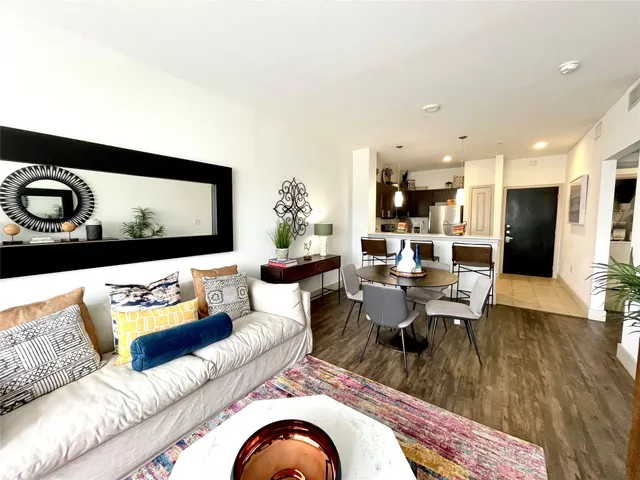 a living room with furniture and kitchen view