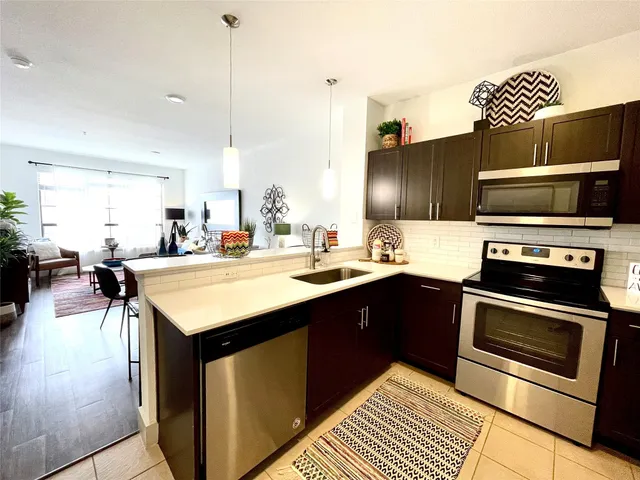 a kitchen with a sink cabinets and stainless steel appliances