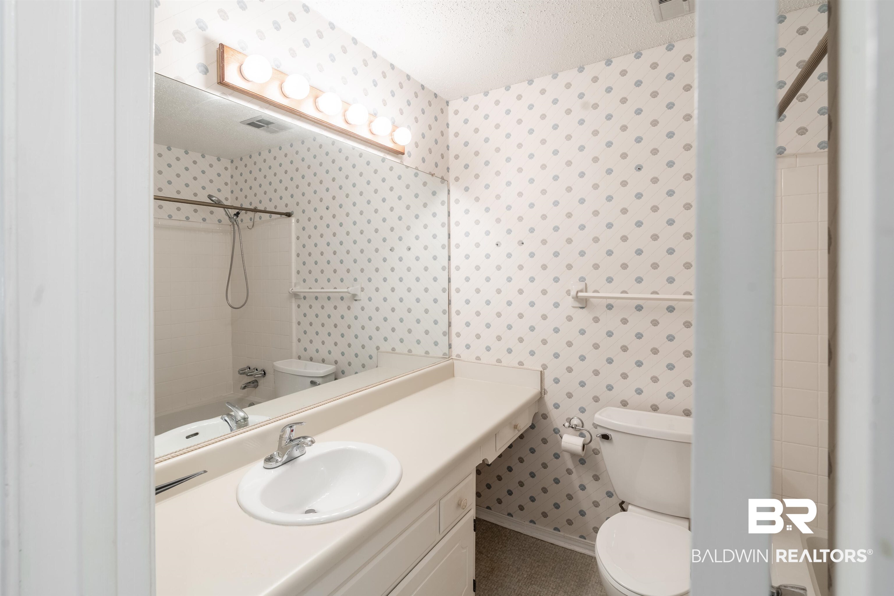 9751 Pine Knoll Road Mobile, AL 36608 - Photo 16 of 36 Bathroom featuring shower combination, wallpapered walls, vanity, and a textured ceiling