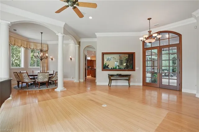 a view of a room with a large window and wooden floor