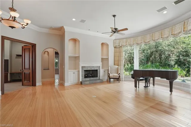 a dining room with furniture a chandelier and wooden floor