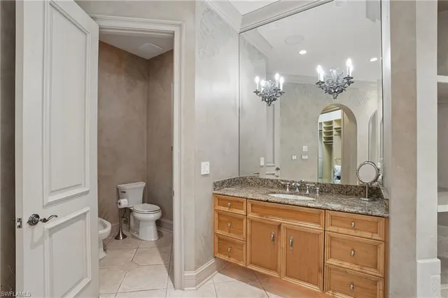 a bathroom with a granite countertop sink a large mirror and a shower