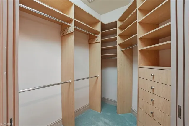 a spacious bathroom with a granite countertop sink a toilet and a mirror