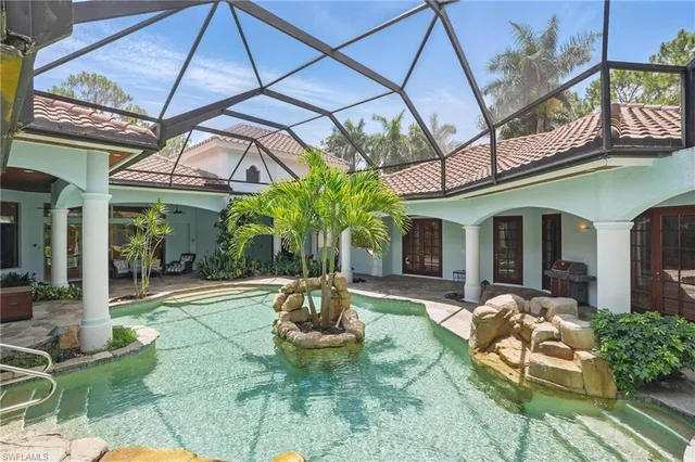 a bathroom with a granite countertop toilet sink and mirror
