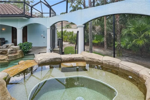 a view of a backyard with a patio table and chairs