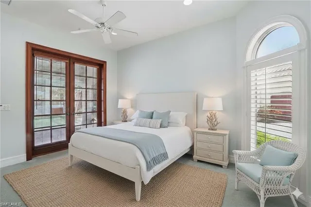 a bedroom with a large bed and a window