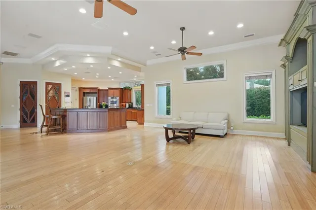a view of a living room and kitchen with furniture wooden floor