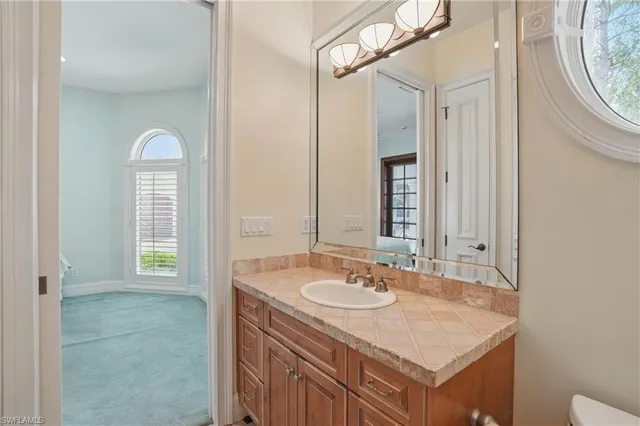 a bedroom with a bed chair and a window