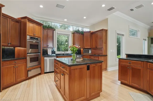 a kitchen with stainless steel appliances granite countertop a stove a sink dishwasher and a refrigerator