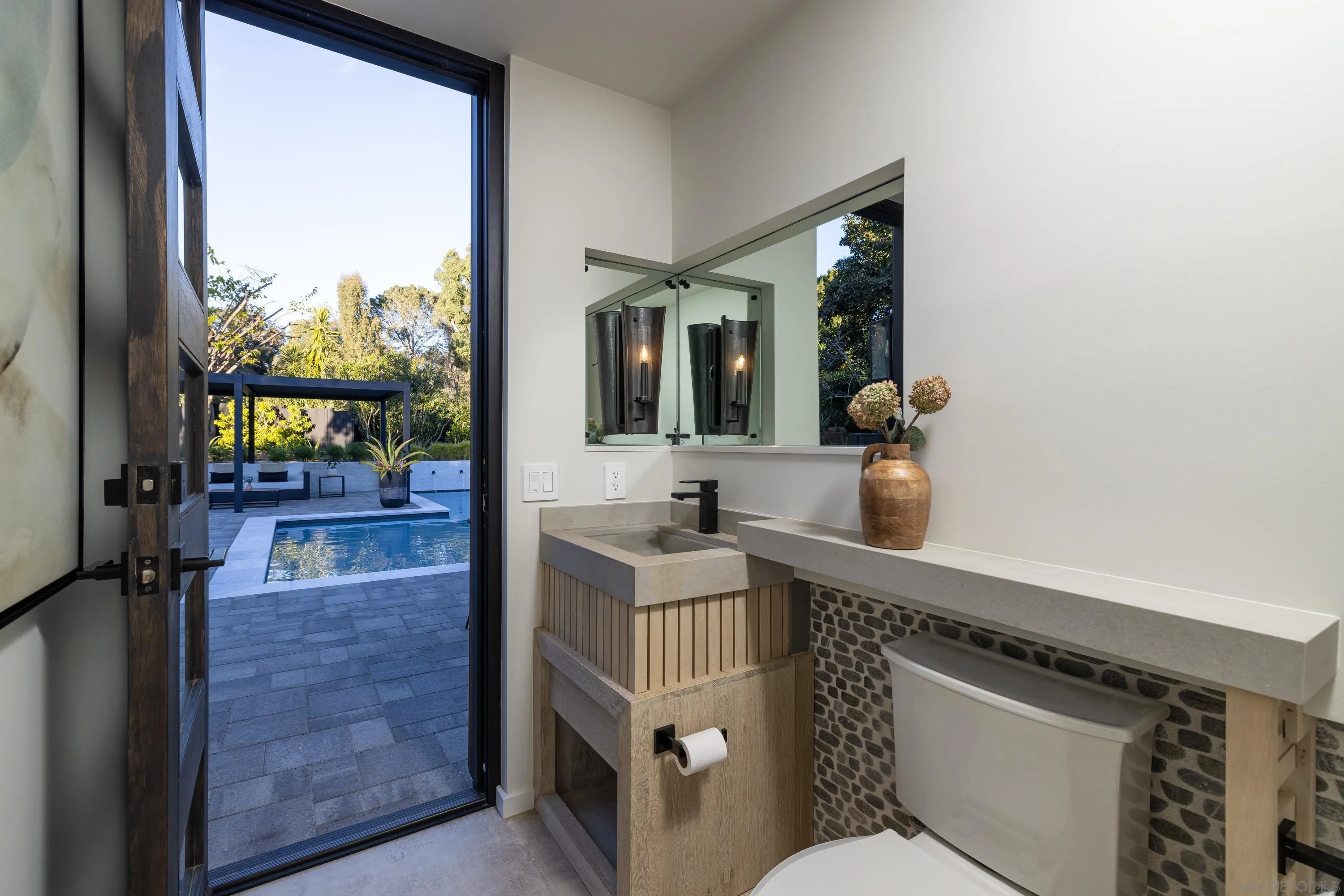 4954 Sun Valley Road Del Mar, CA 92014 - Photo 14 of 31 a bathroom with a sink a mirror and a window