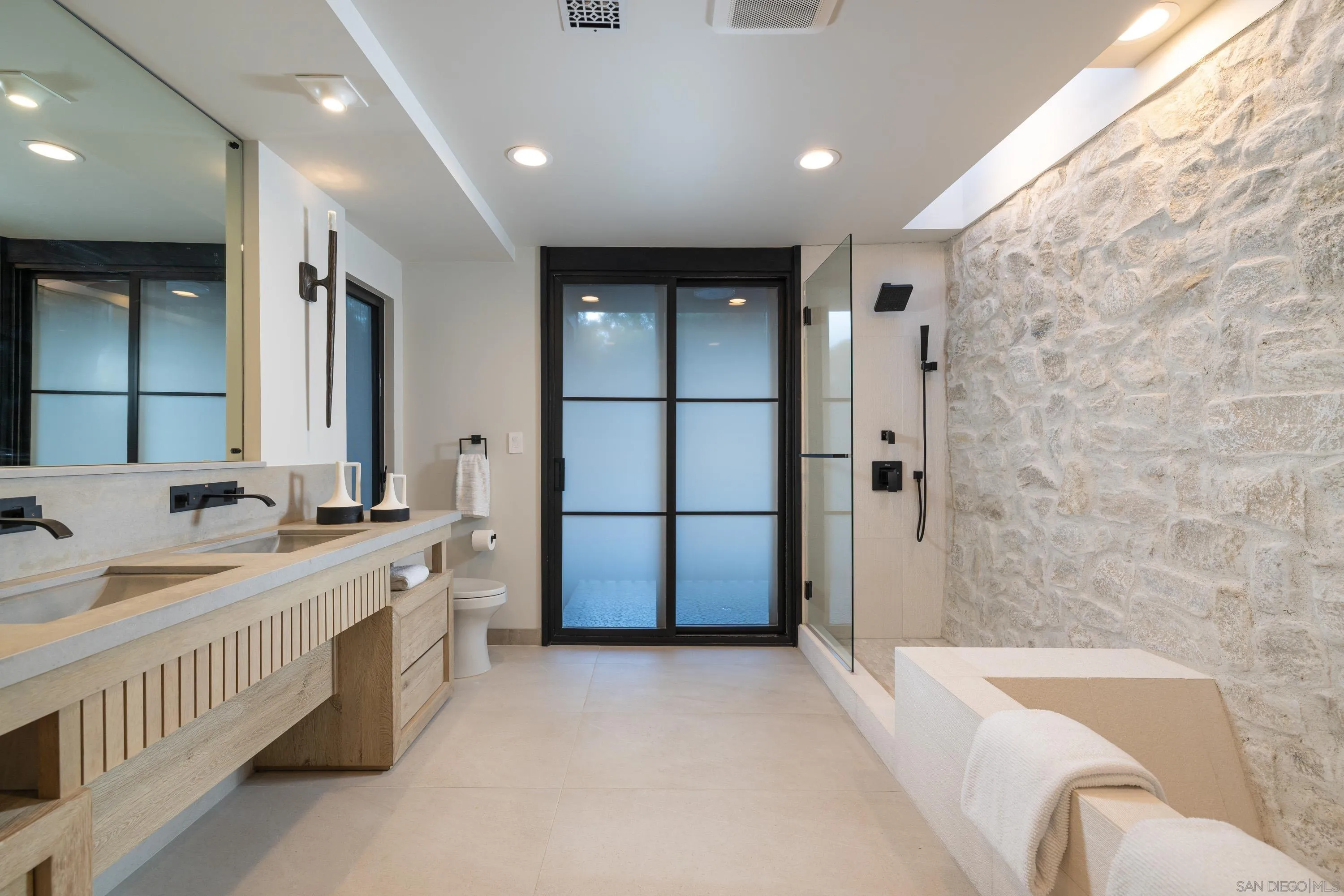 4954 Sun Valley Road Del Mar, CA 92014 - Photo 17 of 31 a bathroom with a bathtub and a sink
