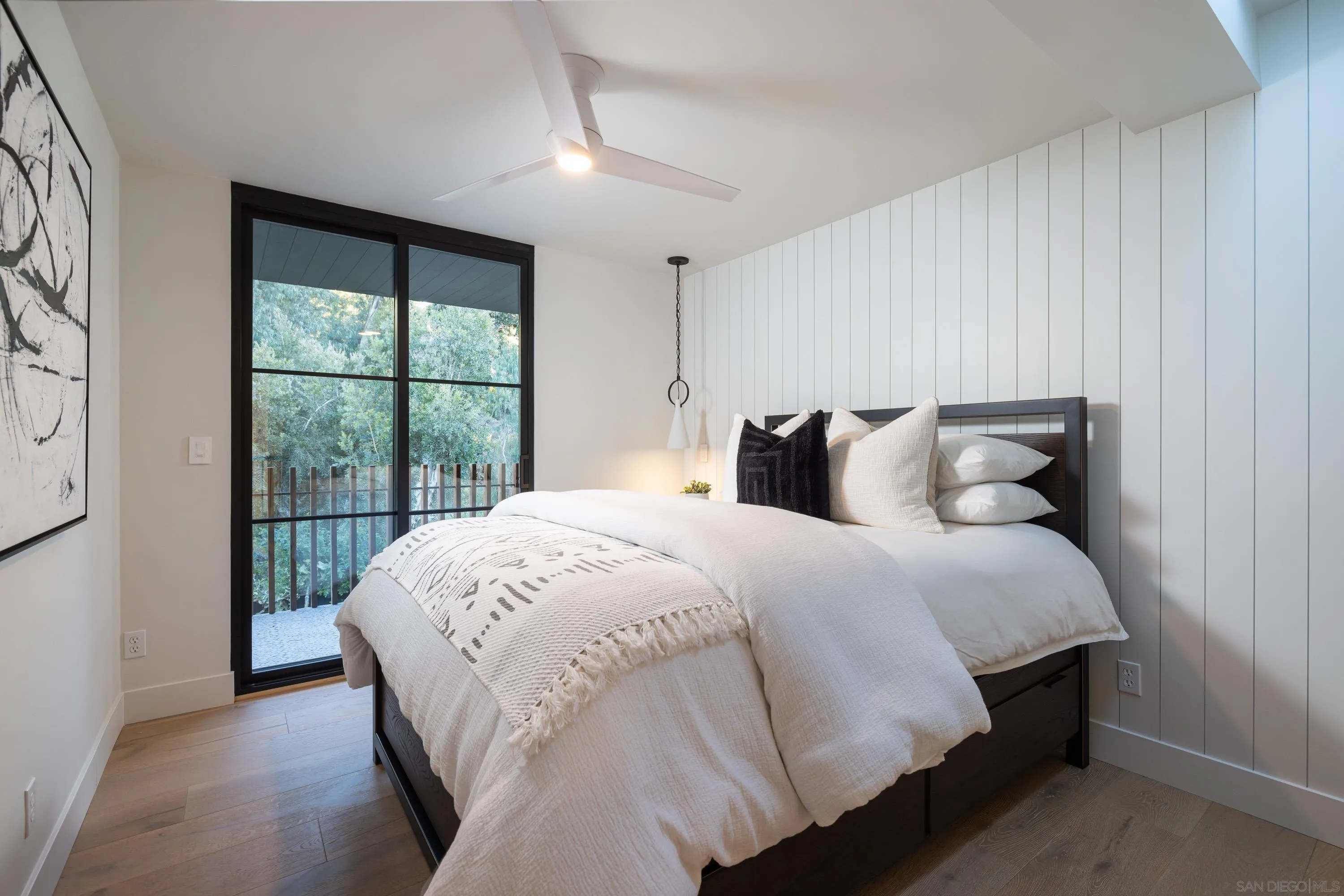 4954 Sun Valley Road Del Mar, CA 92014 - Photo 18 of 31 a bedroom with a bed and a large window