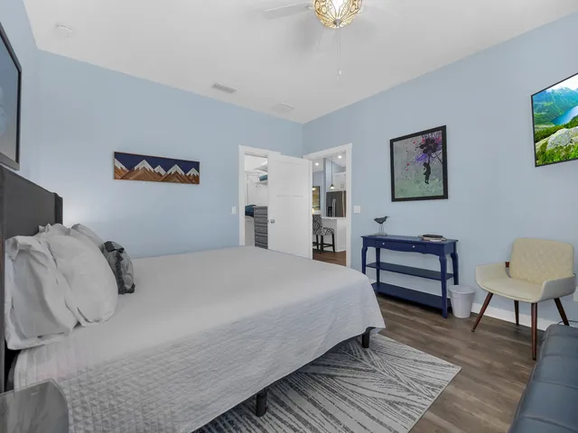 a bedroom with double bed and a desk