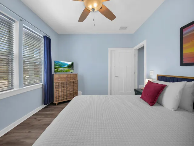 a bedroom with a large bed and a chandelier