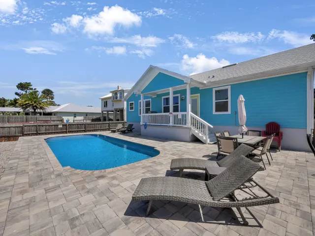 a view of a swimming pool with lounge chairs